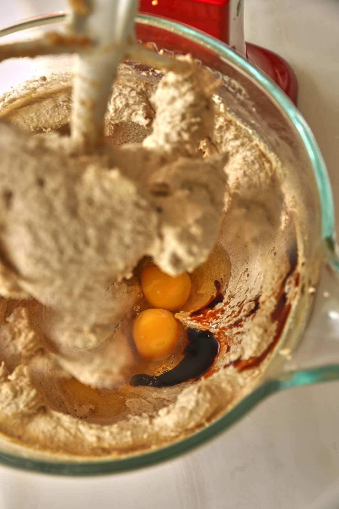 eggs and vanilla added to creamed butter and sugar in a stand mixer bowl.