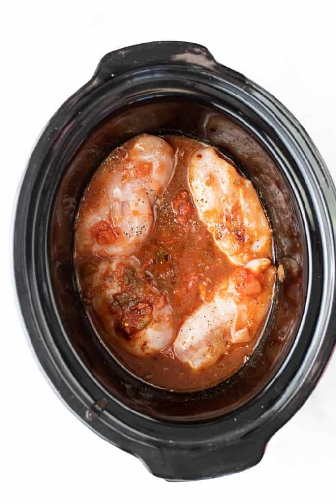 Raw chicken in the slow cooker with sauce