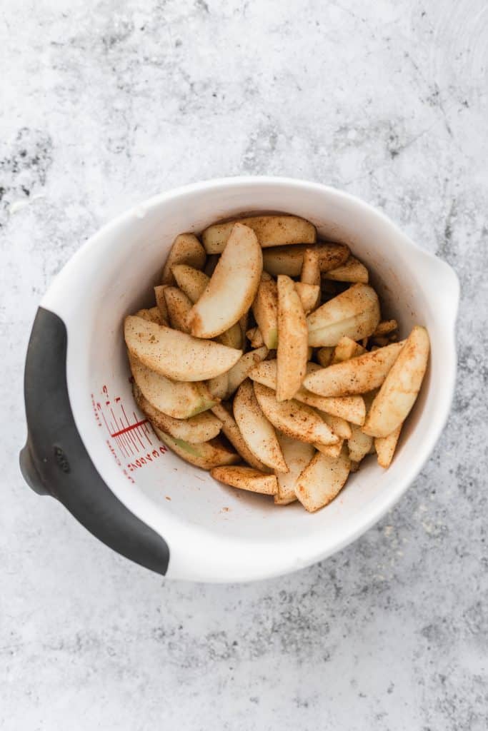 Cinnamon tossed apples in a mixing bowl