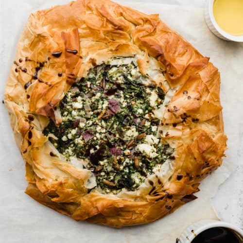 Baked greek spinach pie spanokopita with pomegranate molasses glaze on the side
