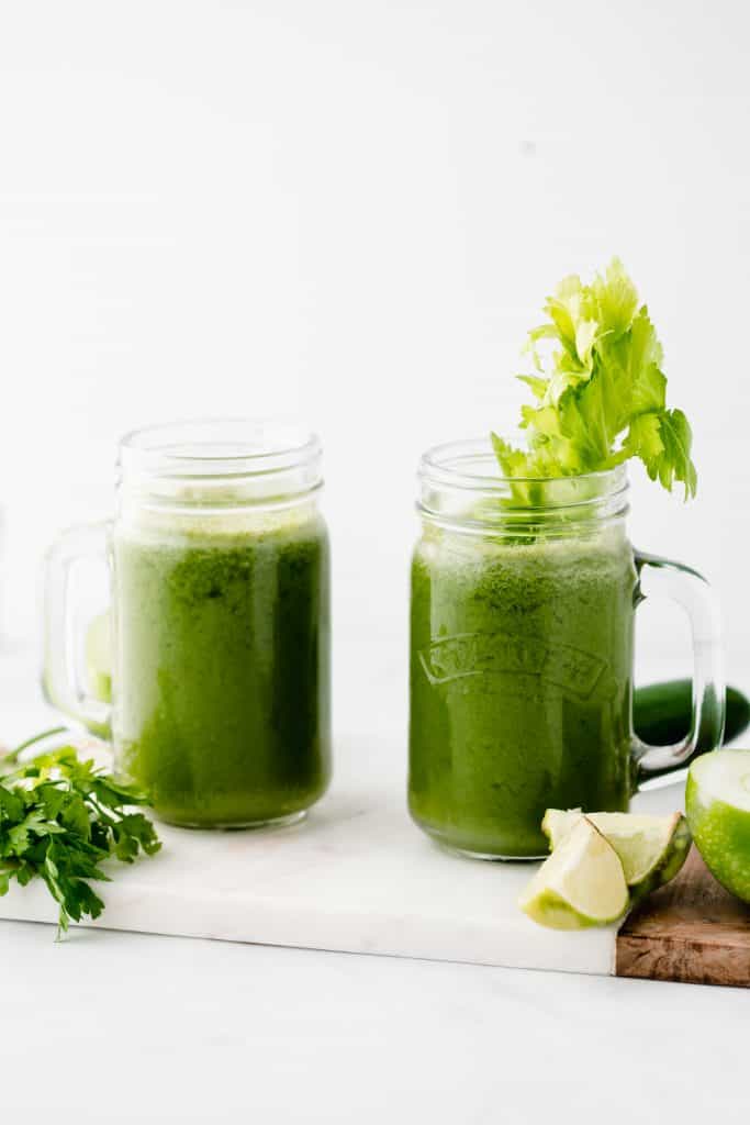 Green Juice recipe in mason jars with celery, parsley and apple