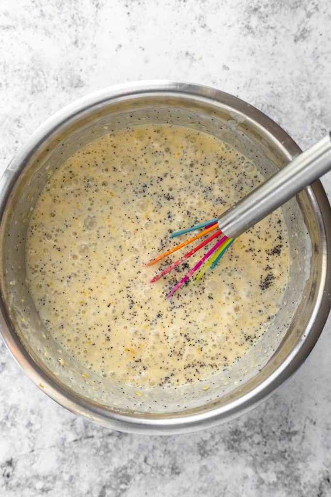 Lemon poppy seed pancake batter in mixing bowl with whisk