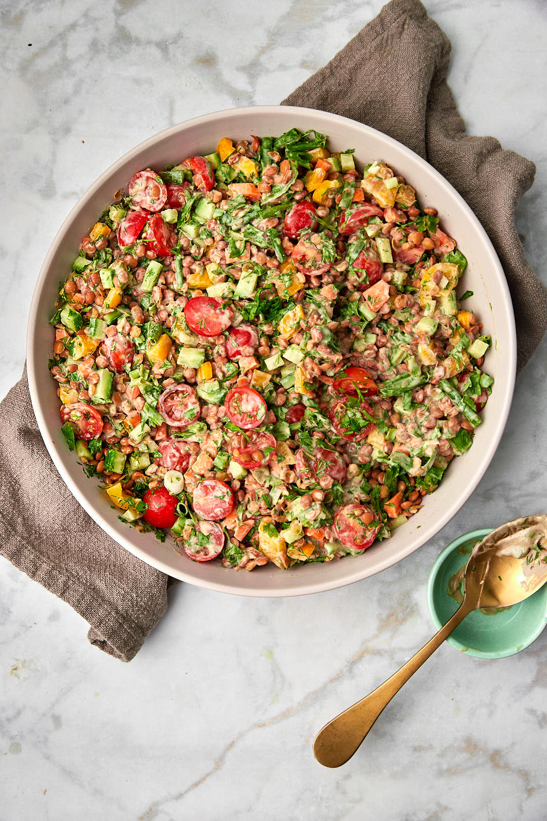 Lentil salad on a kitchen towel on a white background.