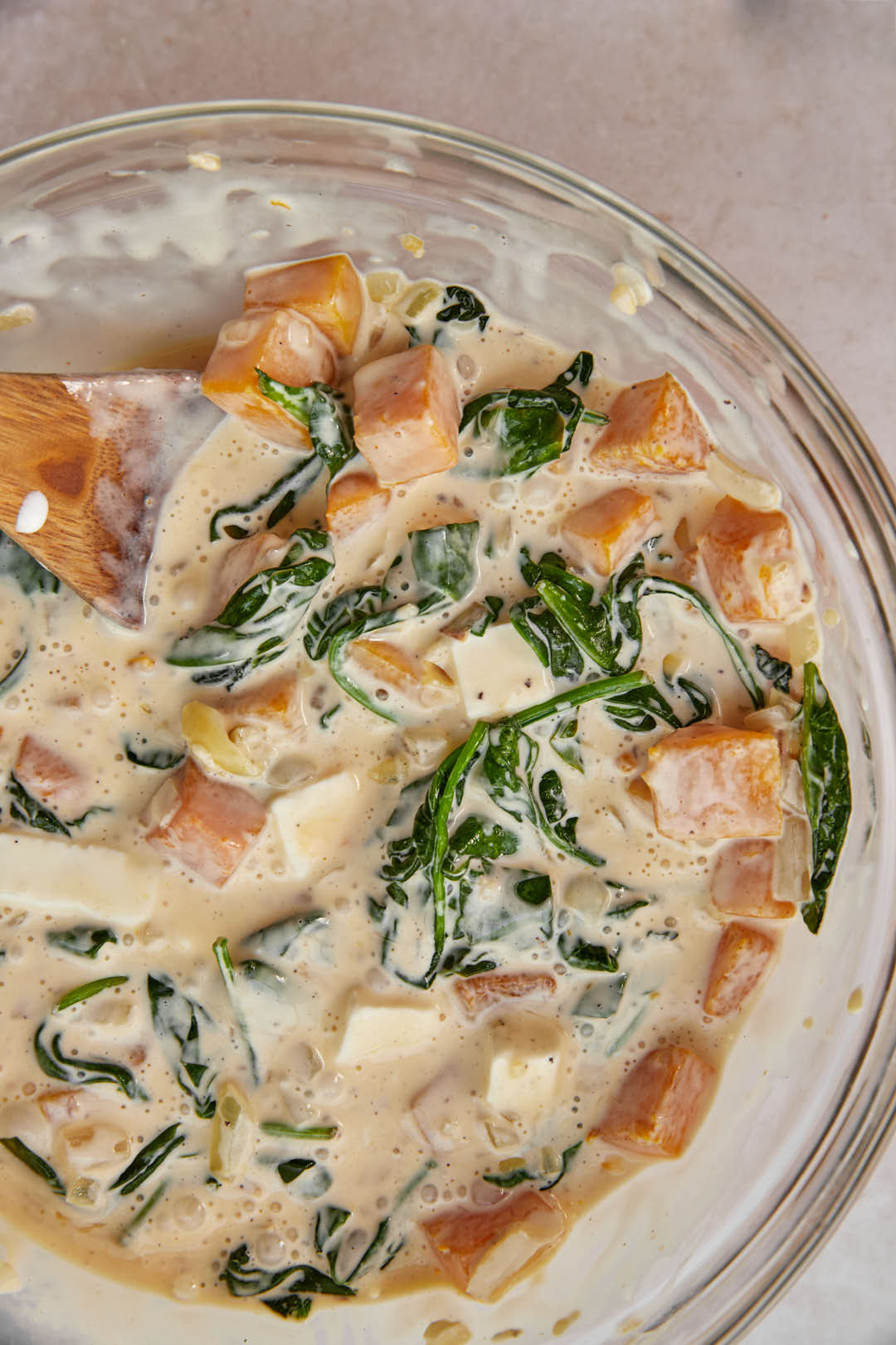 mixed pumpkin feta quiche batter in a glass bowl.