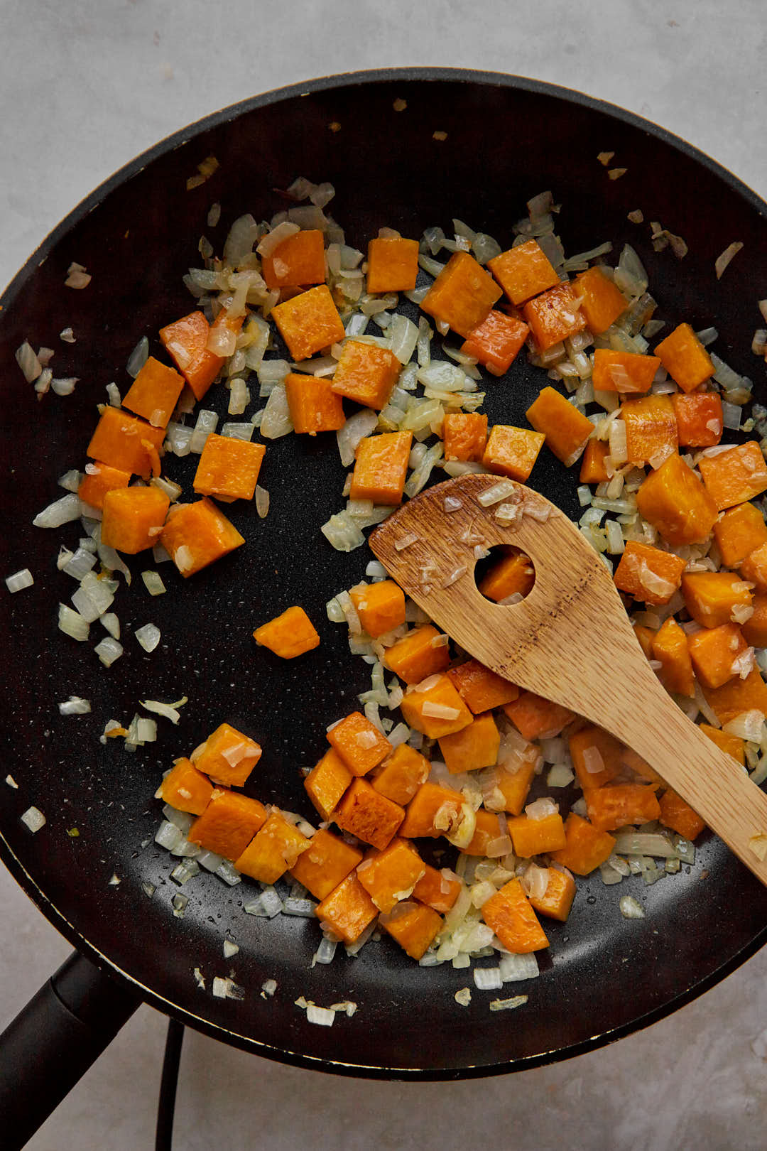 Sauteed pumpkin cubes and diced onion in large skillet.