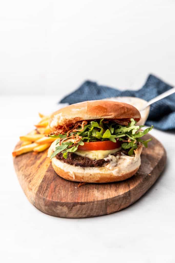 air fryer burger on wooden plate with fries