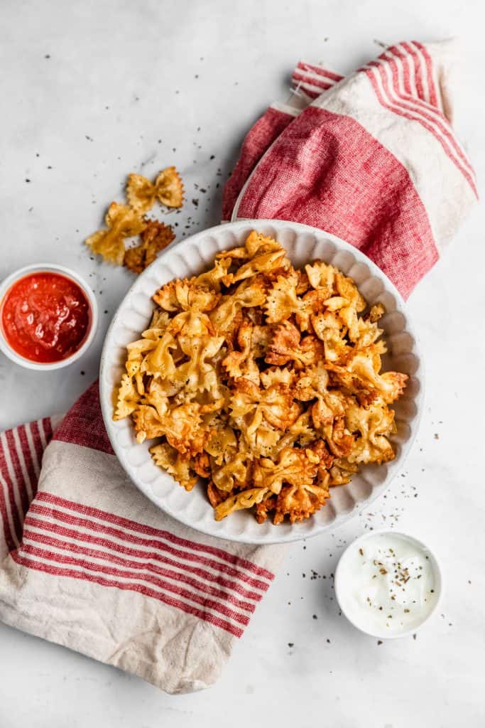 bowl of air fried pasta with dipping sauces
