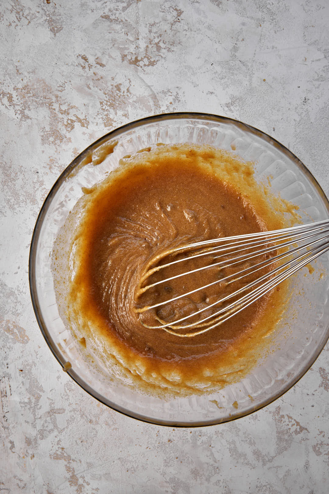 butter and sugar whisked together in glass bowl.