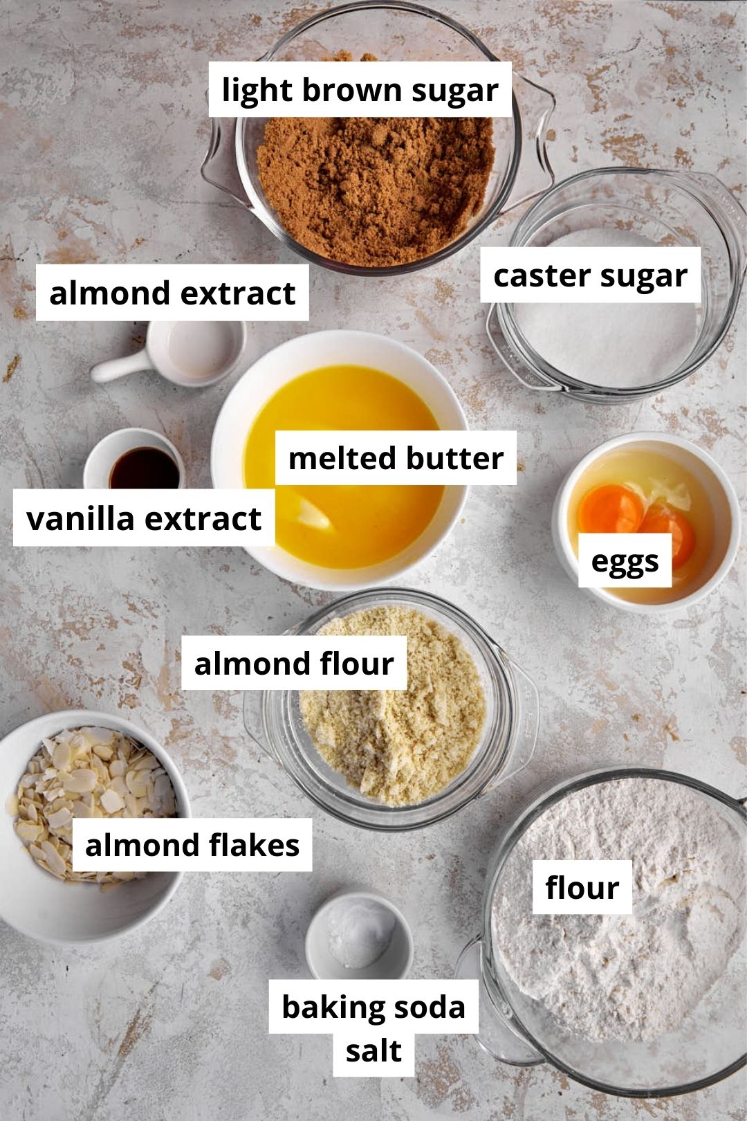 ingredients you need to make almond croissant cookies on a white background.