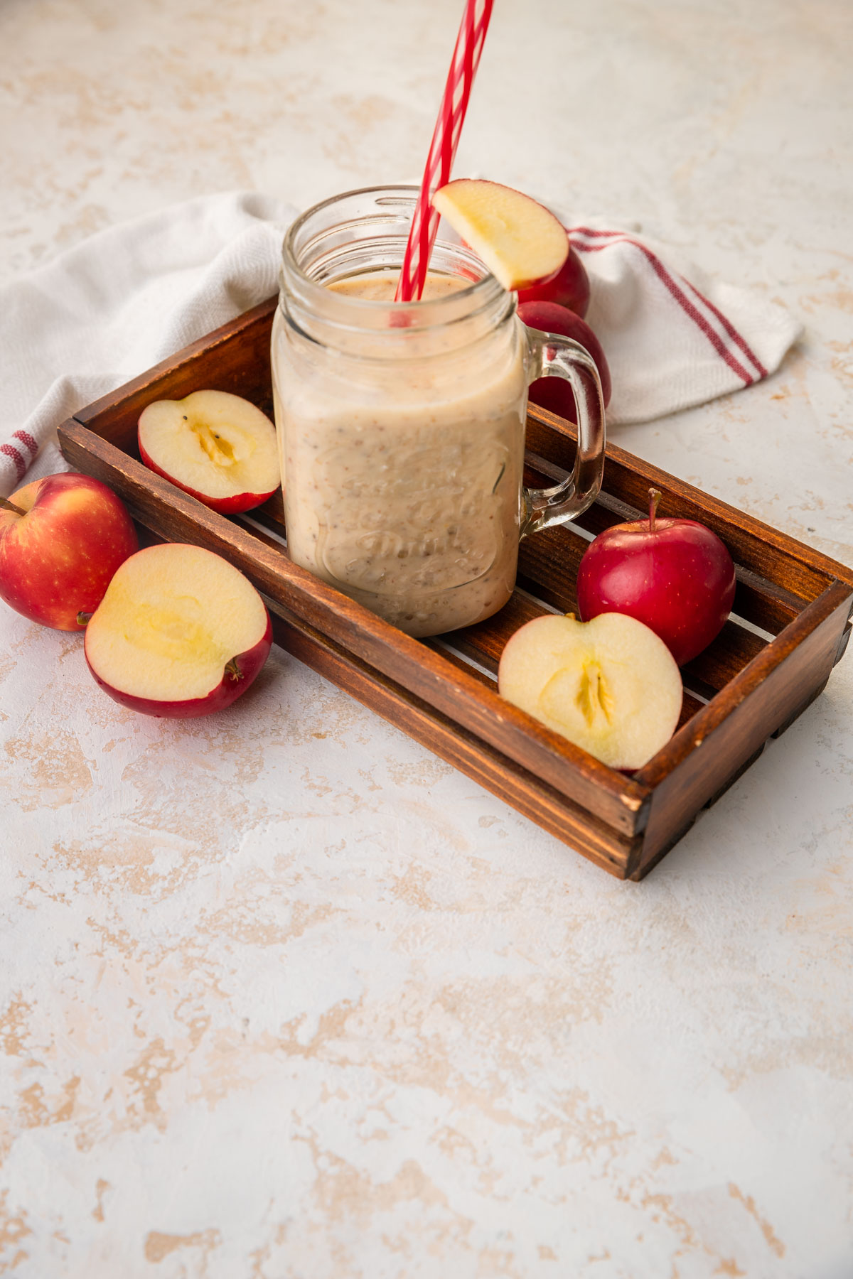 apple date smoothie with cut up apples scattered around.