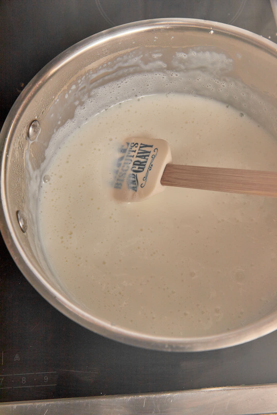 custard in a saucepan with a spatula in it.