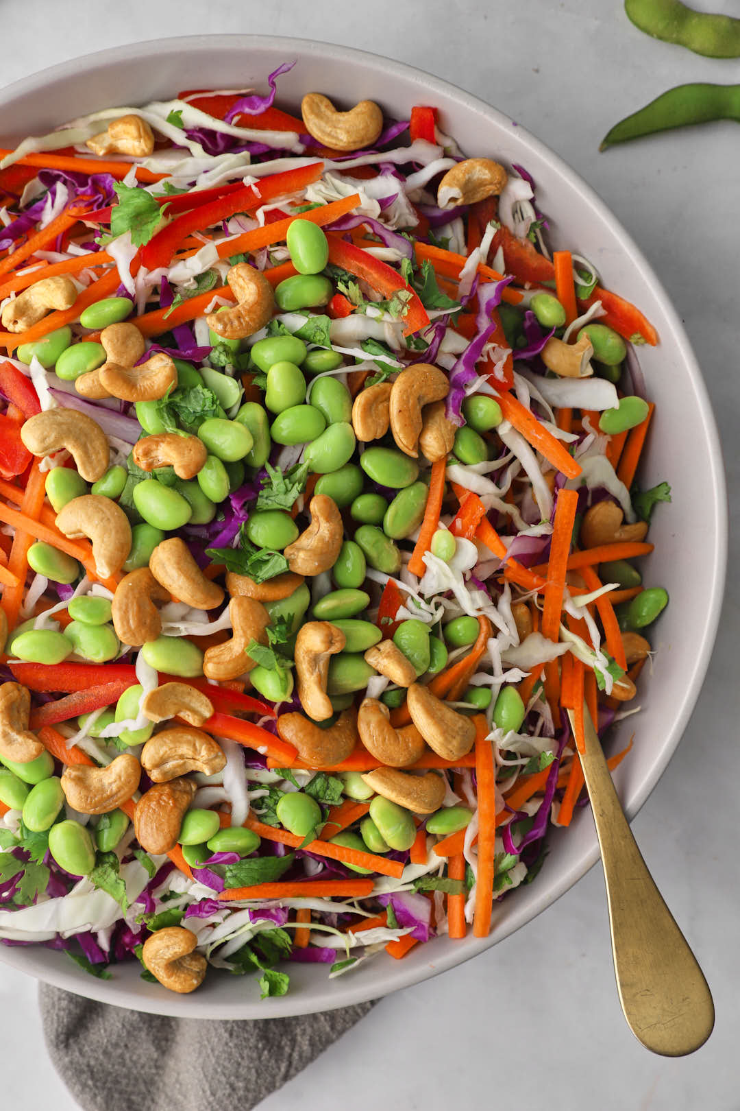 edamame and cashews on top of Asian salad ingredients.