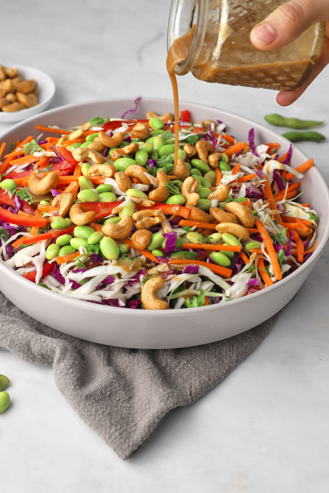salad dressing drizzled onto asian salad.