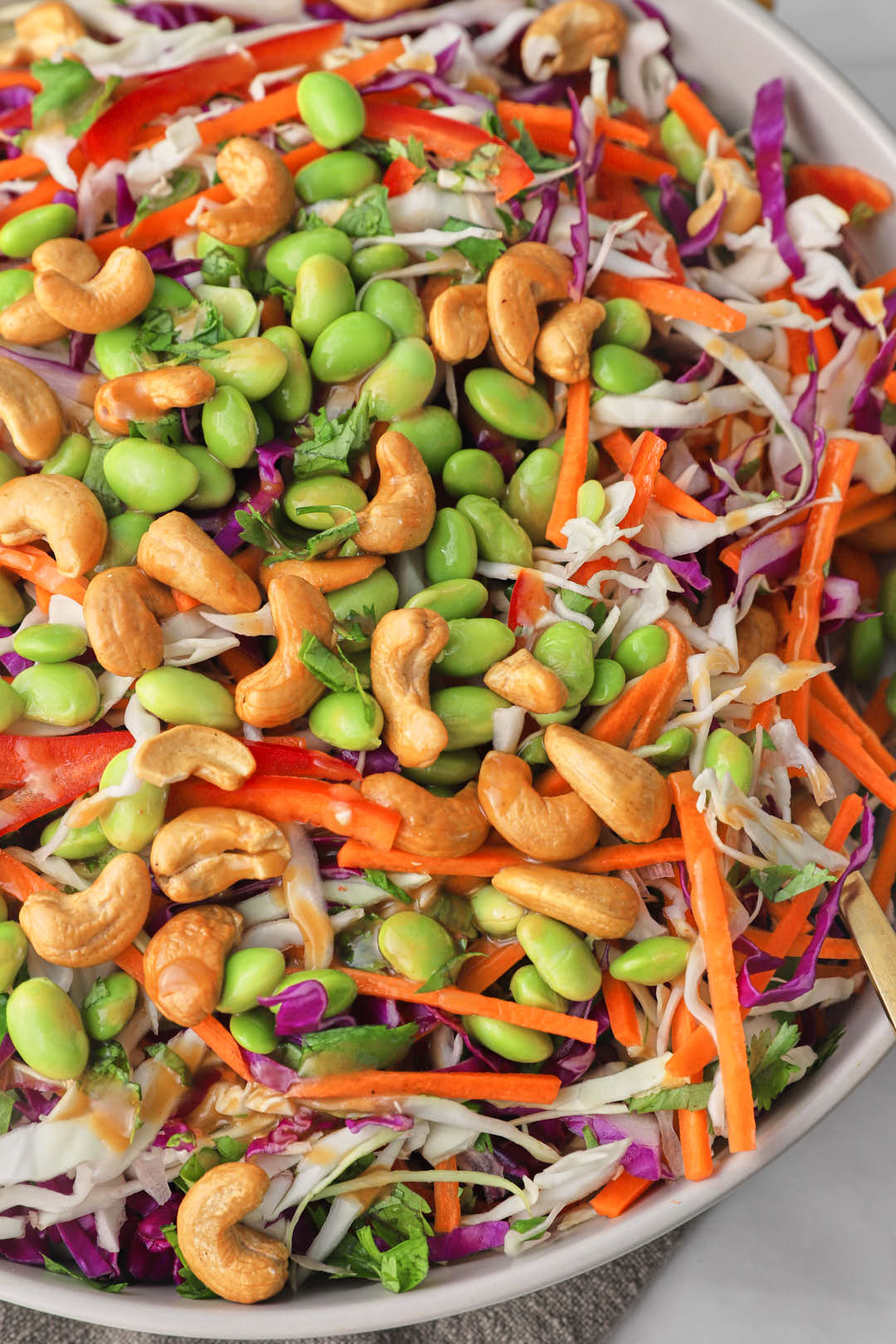 close up photo of asian cashew salad in a large serving dish.