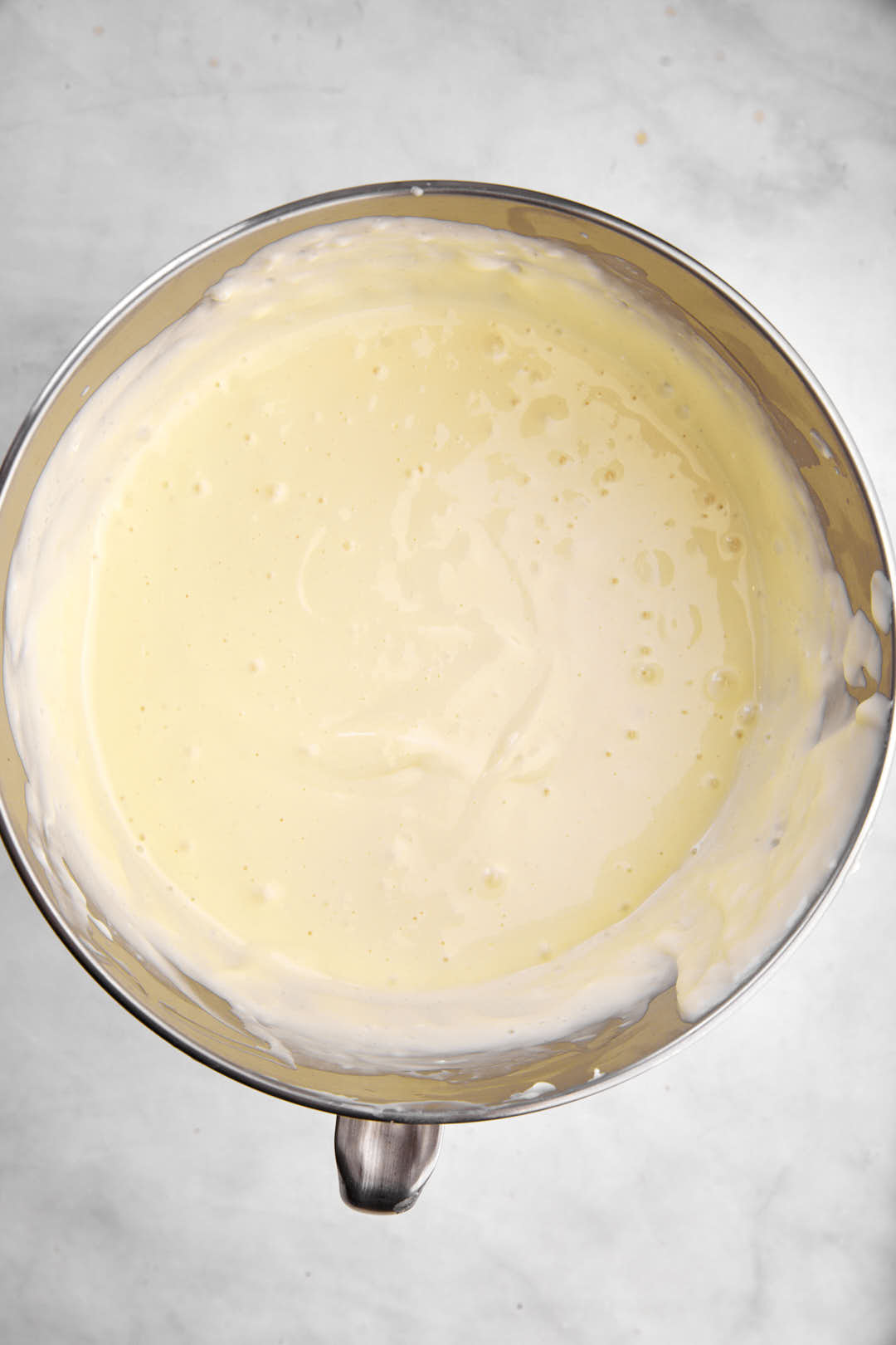 smooth cheesecake batter in stand mixer bowl.
