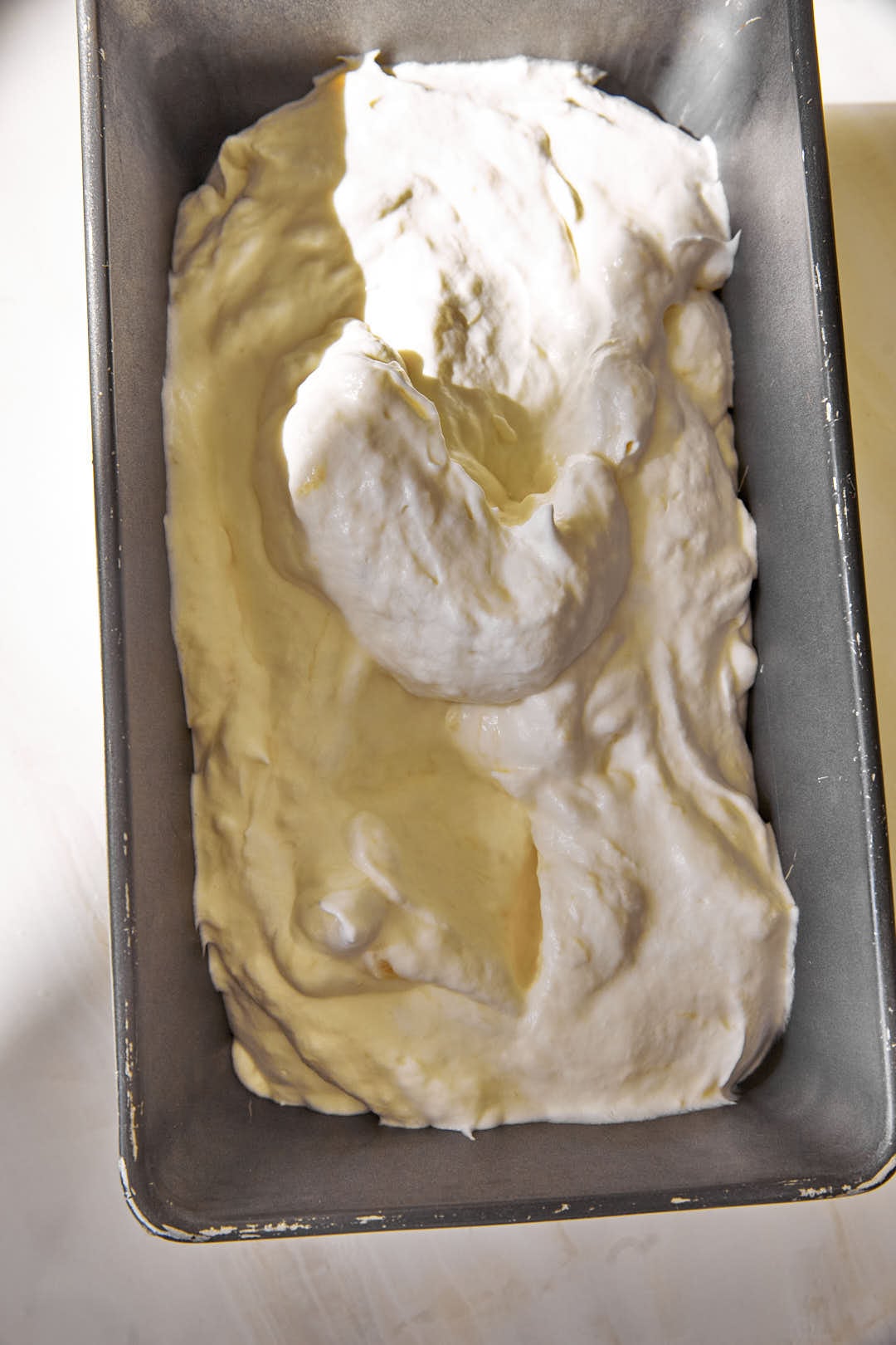 one layer of banoffee ice cream in a loaf pan.