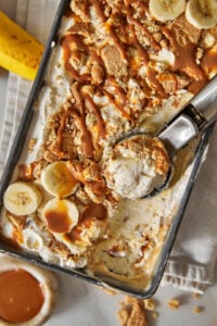 banoffee ice cream in a loaf pan with an ice cream scoop.