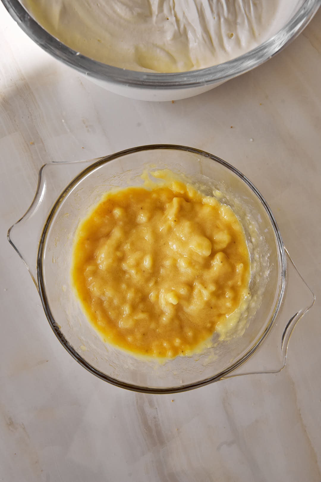 mashed bananas in a small glass bowl.