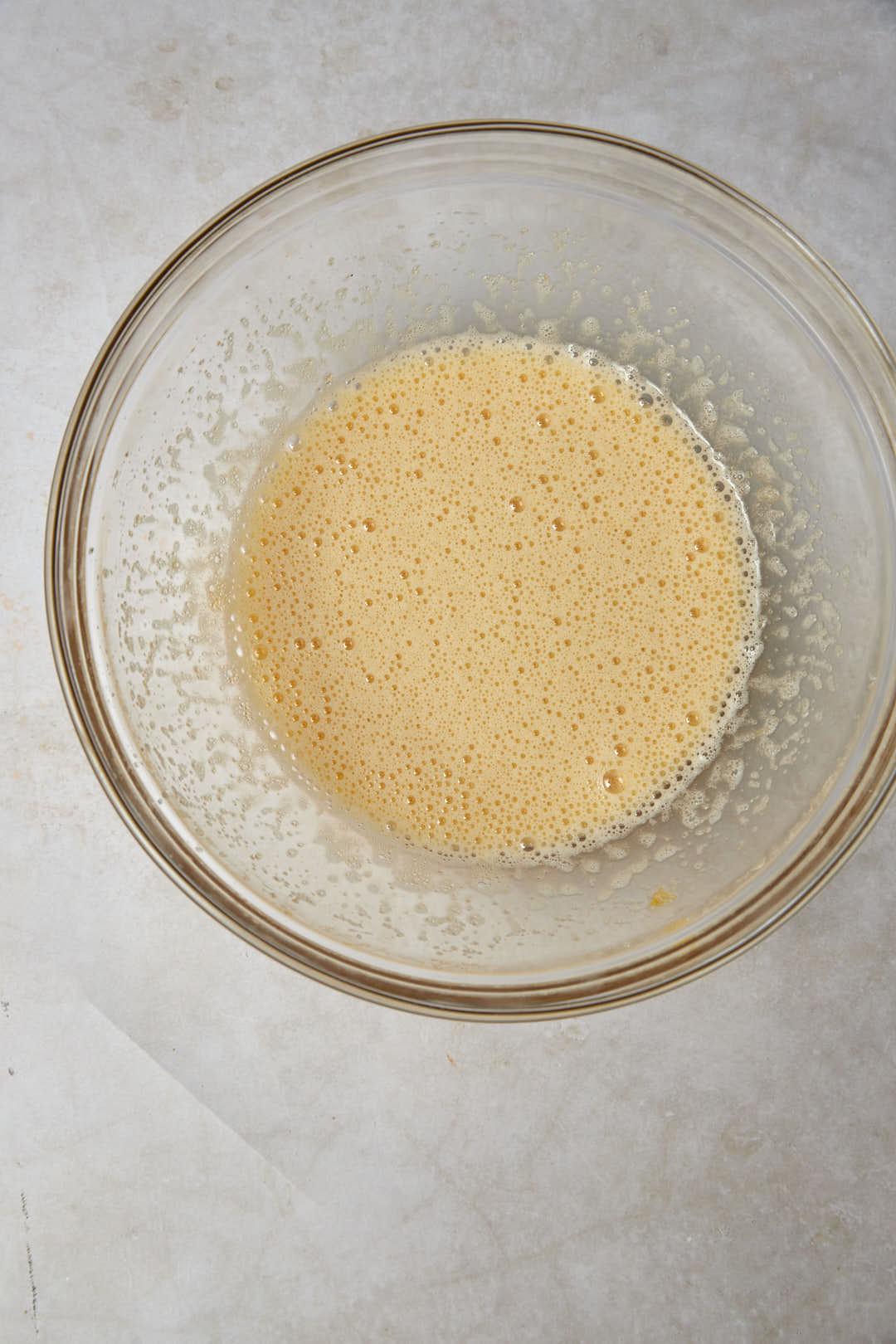beaten eggs and sugar in a glass bowl.