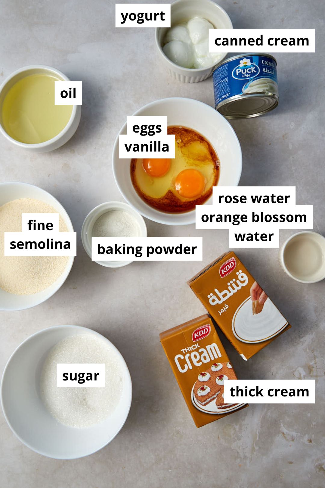 basbousa ingredients on a white marble background.
