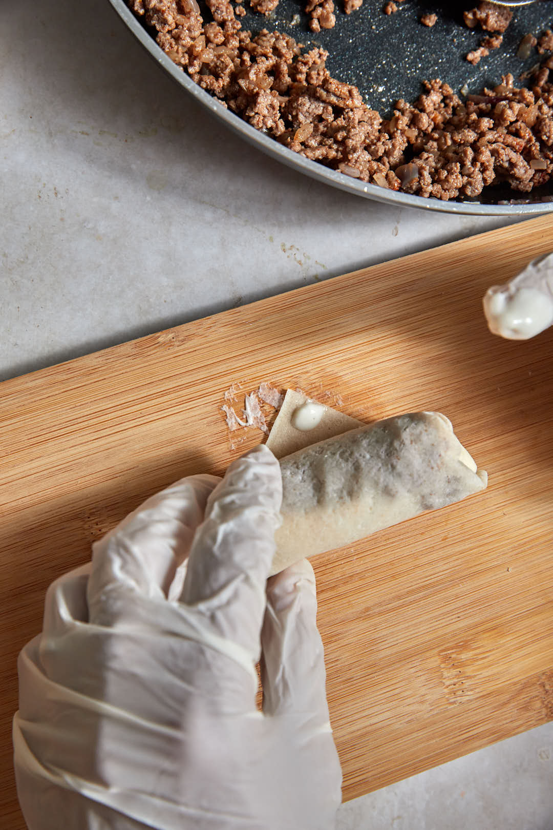spring roll wrapper with a flour water paste sealing the corner.