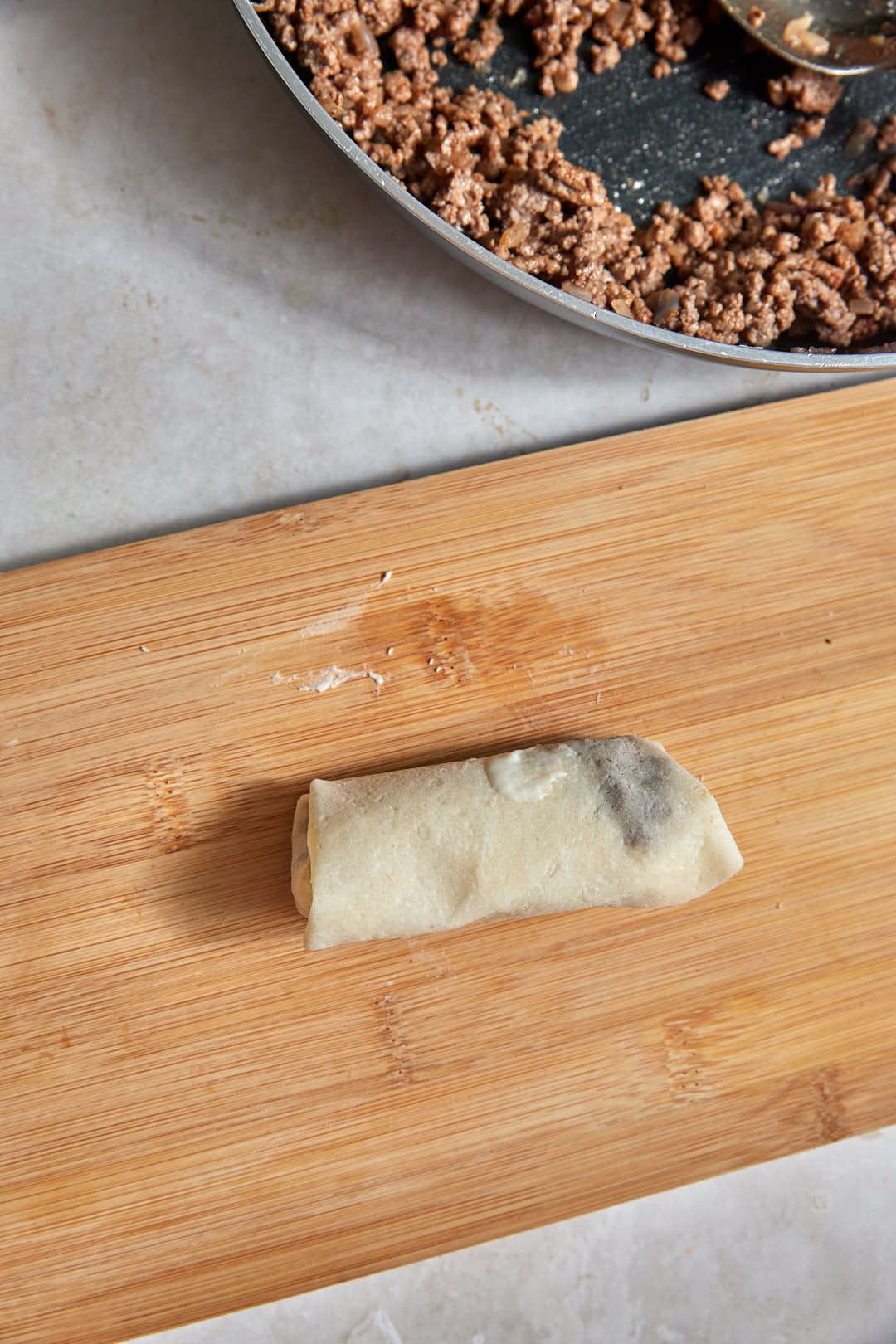assembled spring roll on a wooden board.