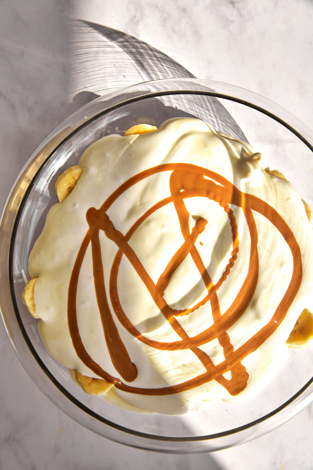drizzle of biscoff spread on pudding mix in a glass bowl.