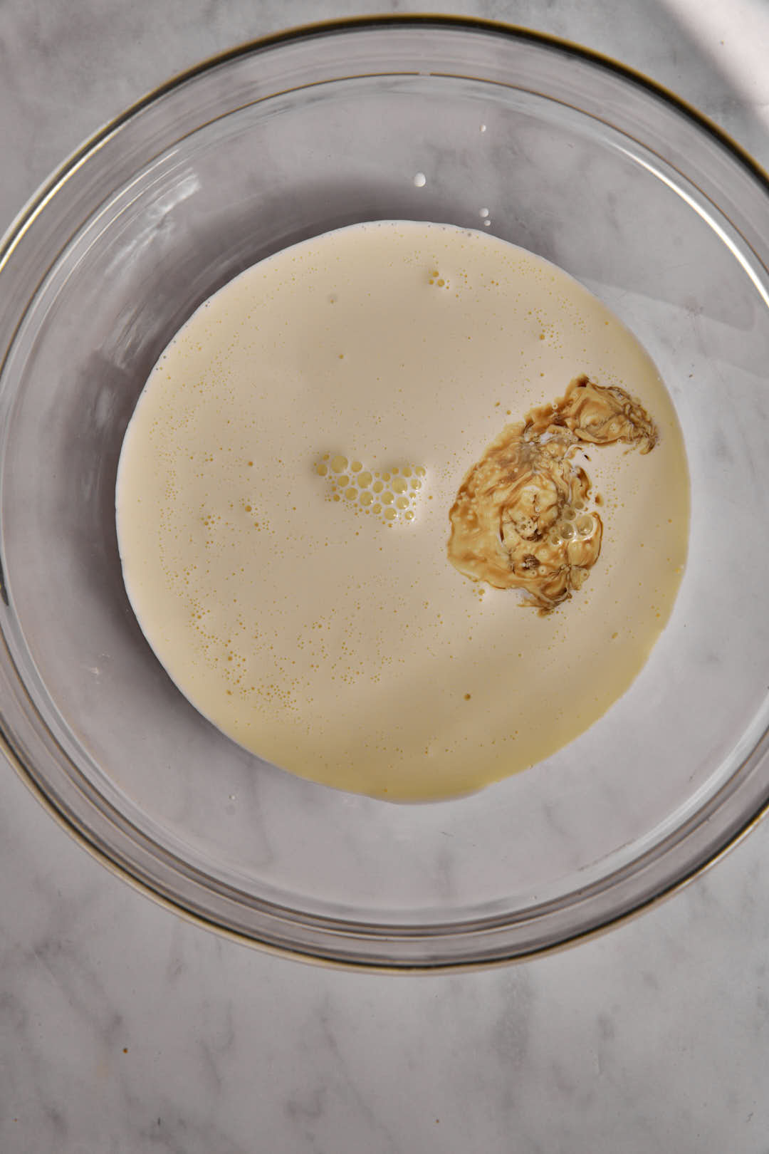 heavy cream and vanilla in a glass bowl.