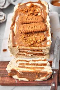 Biscoff icebox cake with a slice cut and a knife by the side.