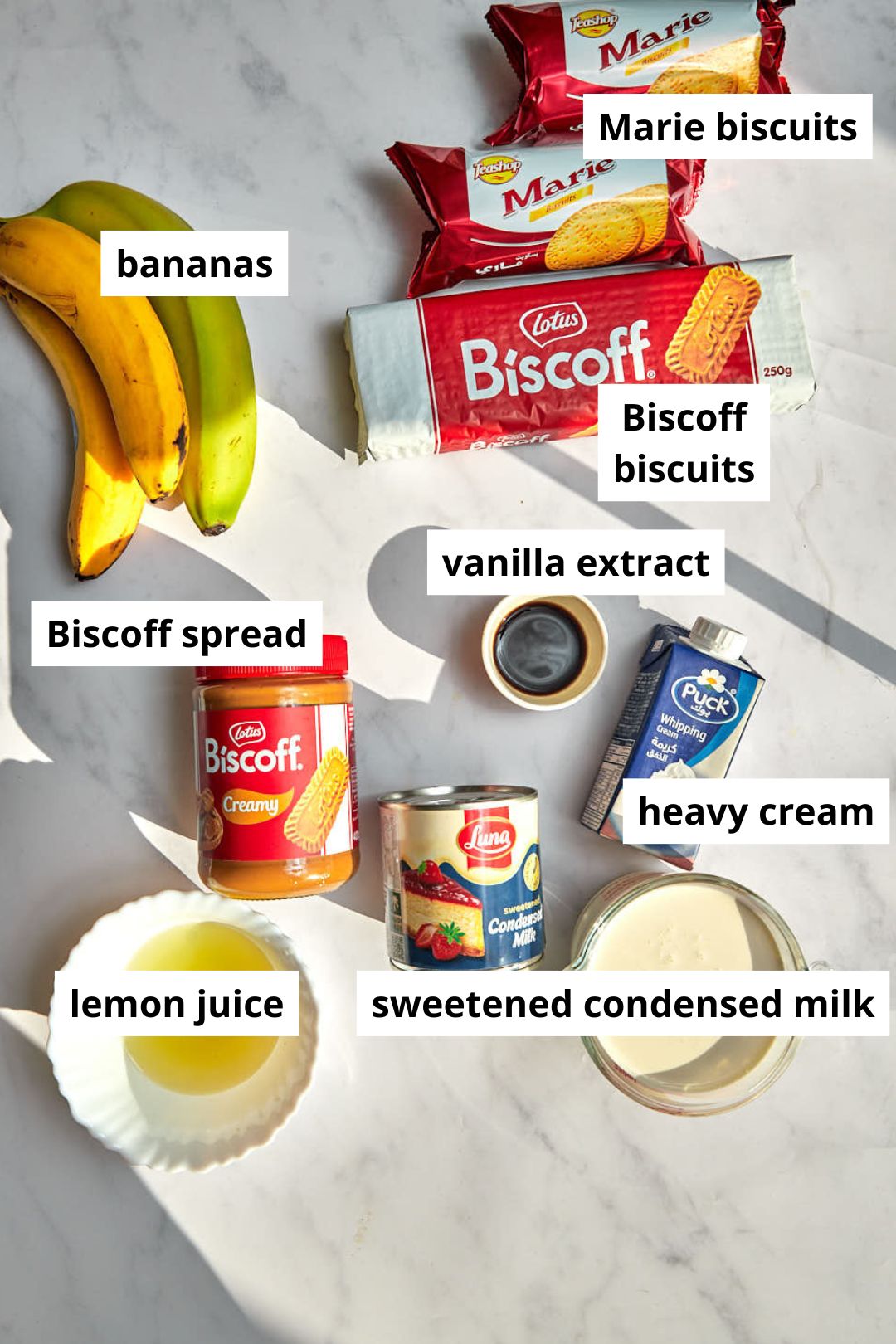 ingredients needed to make biscoff banana pudding on a white background.