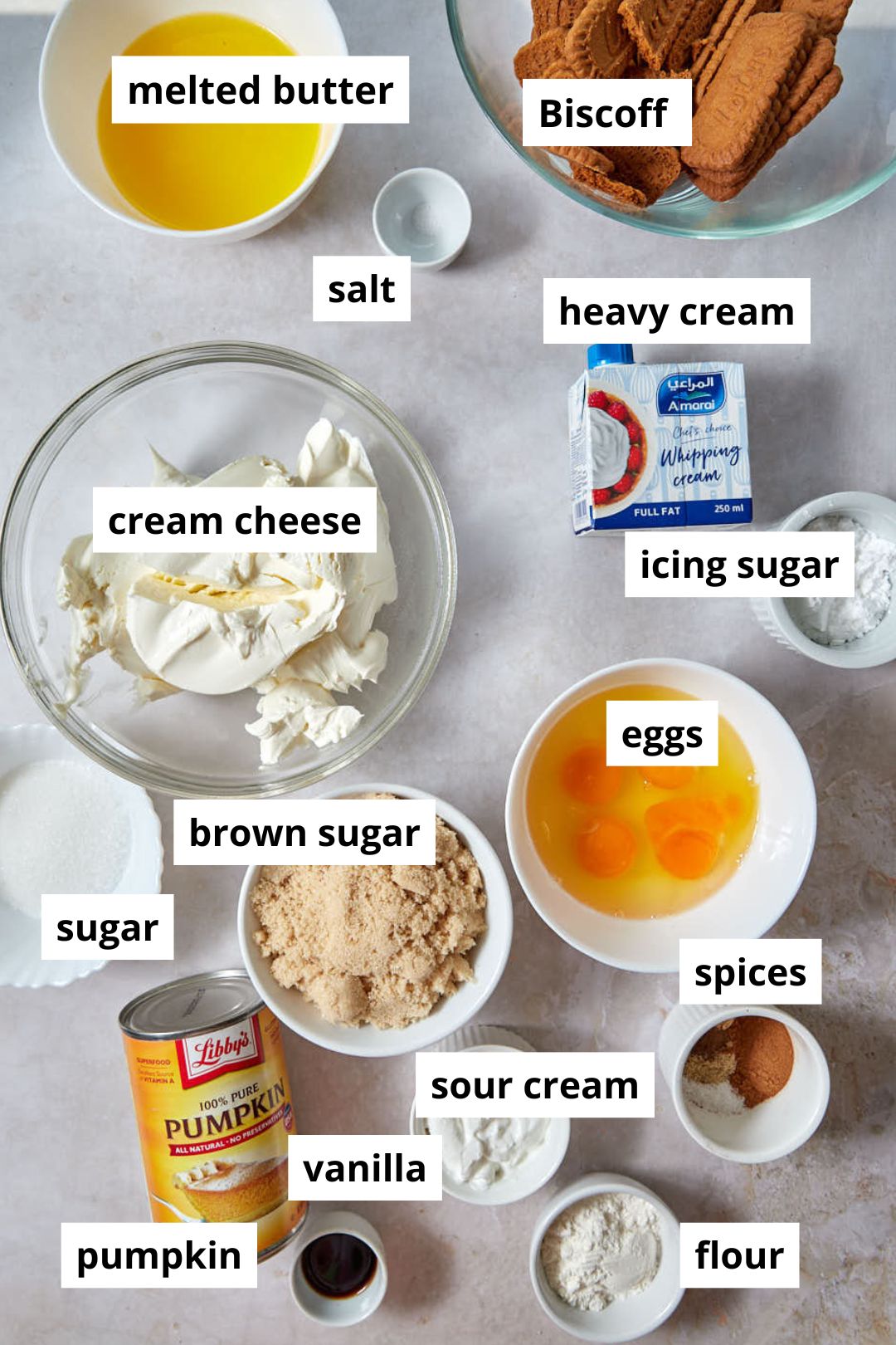 ingredients for pumpkin cheesecake on marble background.