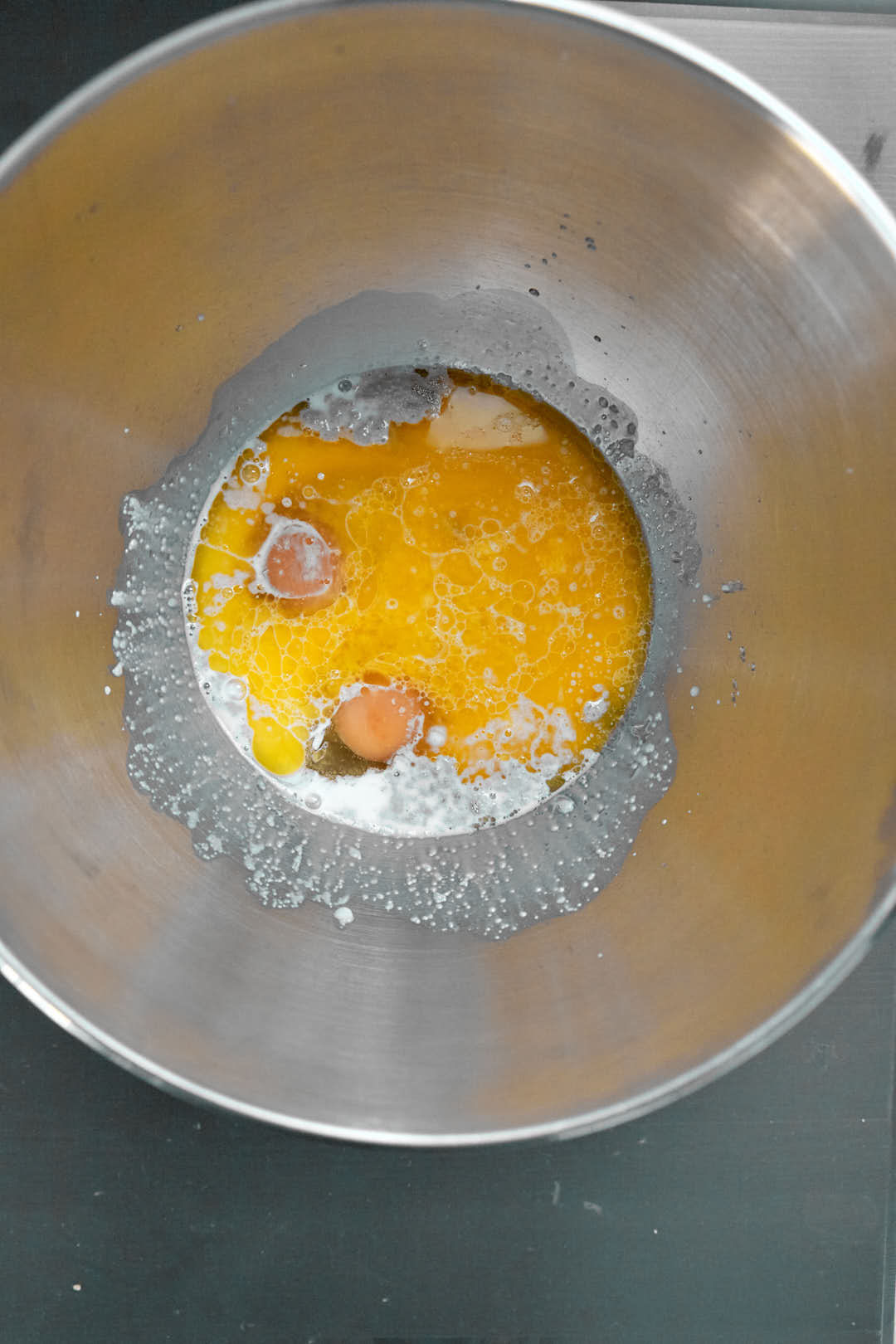 sugar, brown butter and eggs added to the milk and yeast in a mixer.
