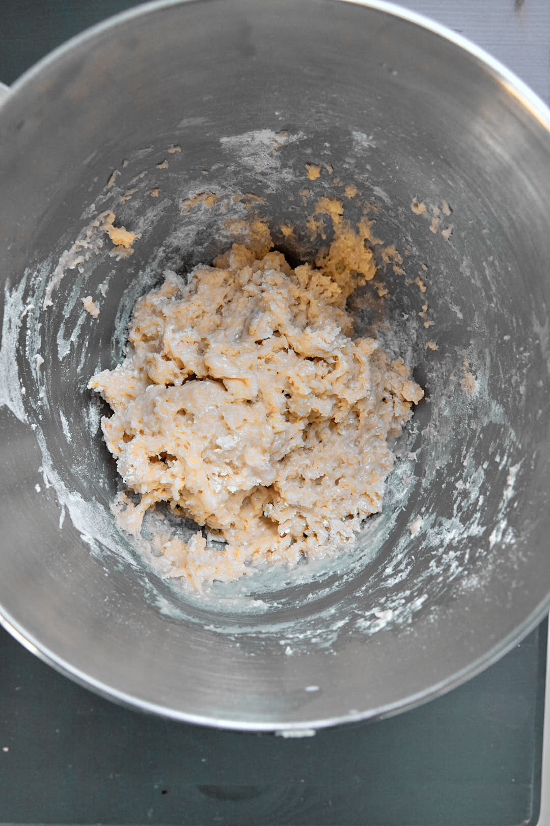 flour stirred into wet ingredients in a stand mixer bowl.
