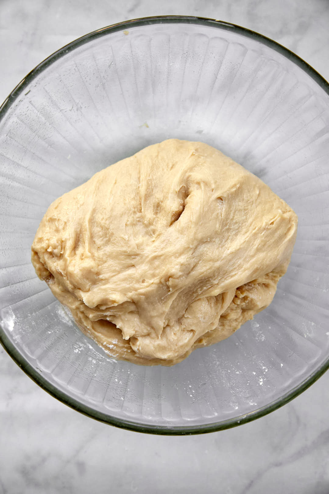 cinnamon roll dough in lightly oiled bowl.