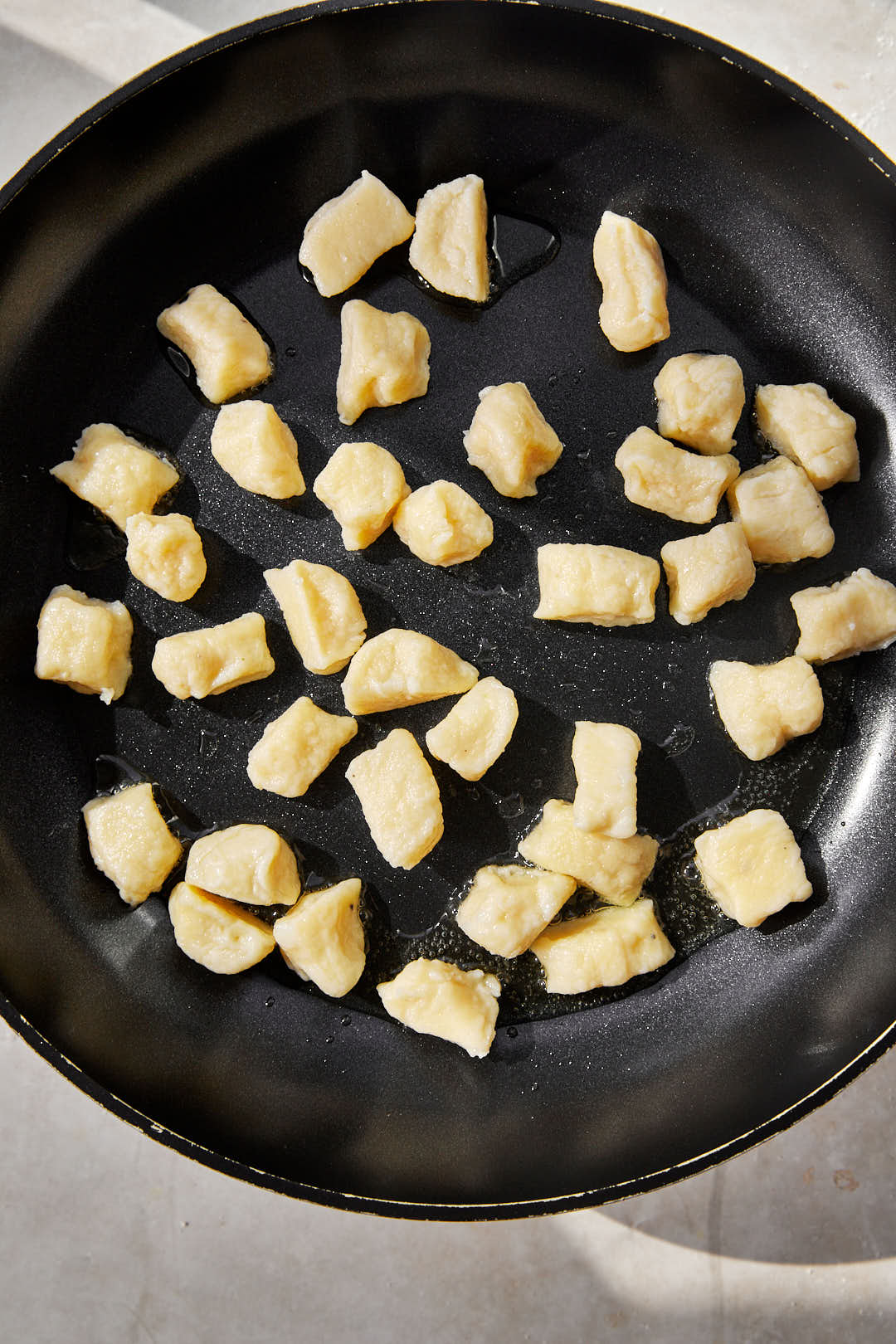 gnocchi being toasted in a hot skillet.