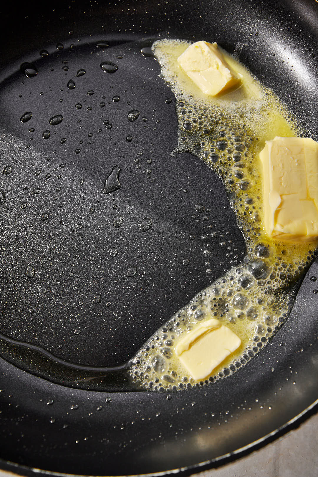 butter melting in a black skillet.