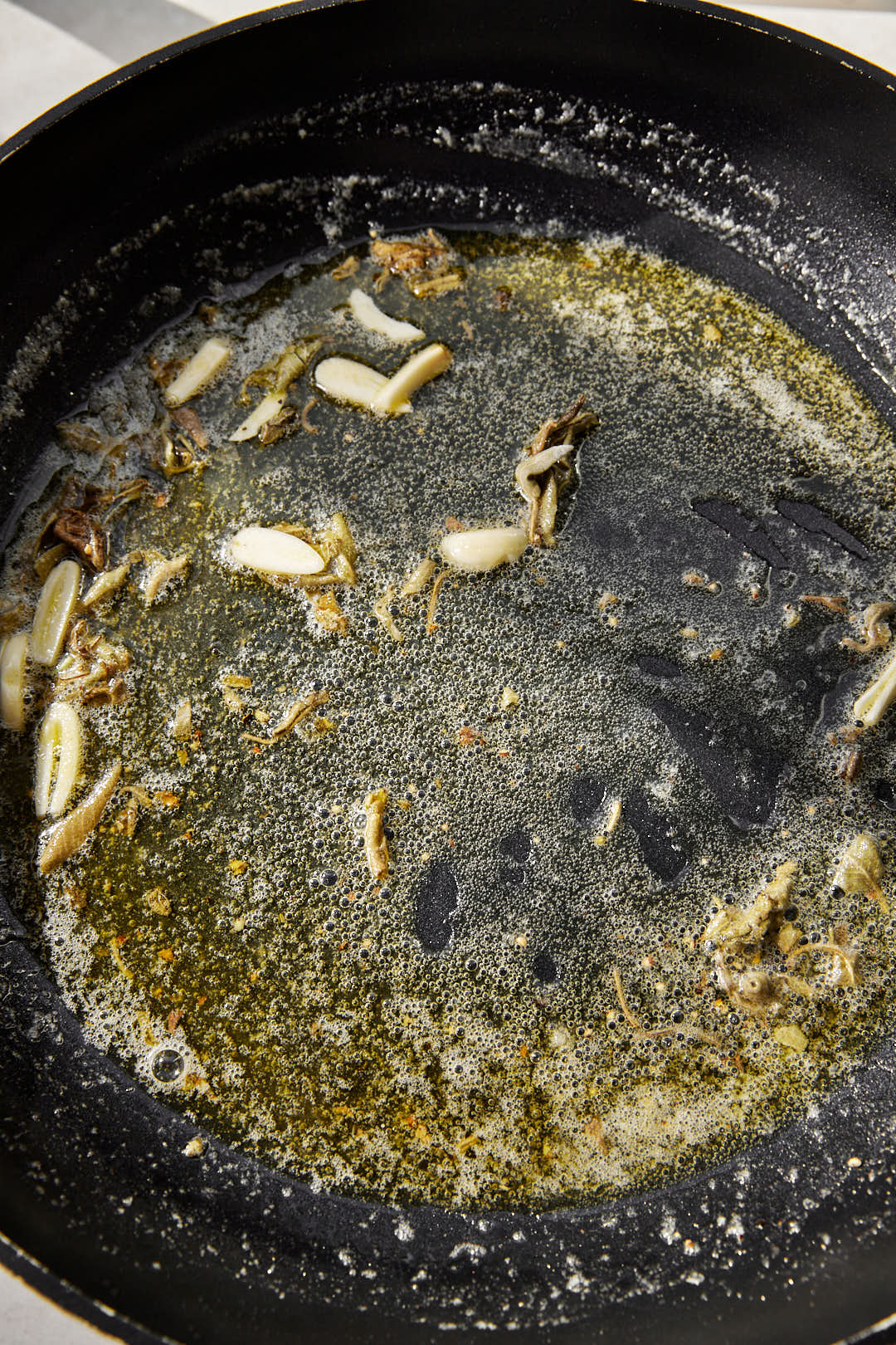dried sage leaves added to brown butter in a skillet.
