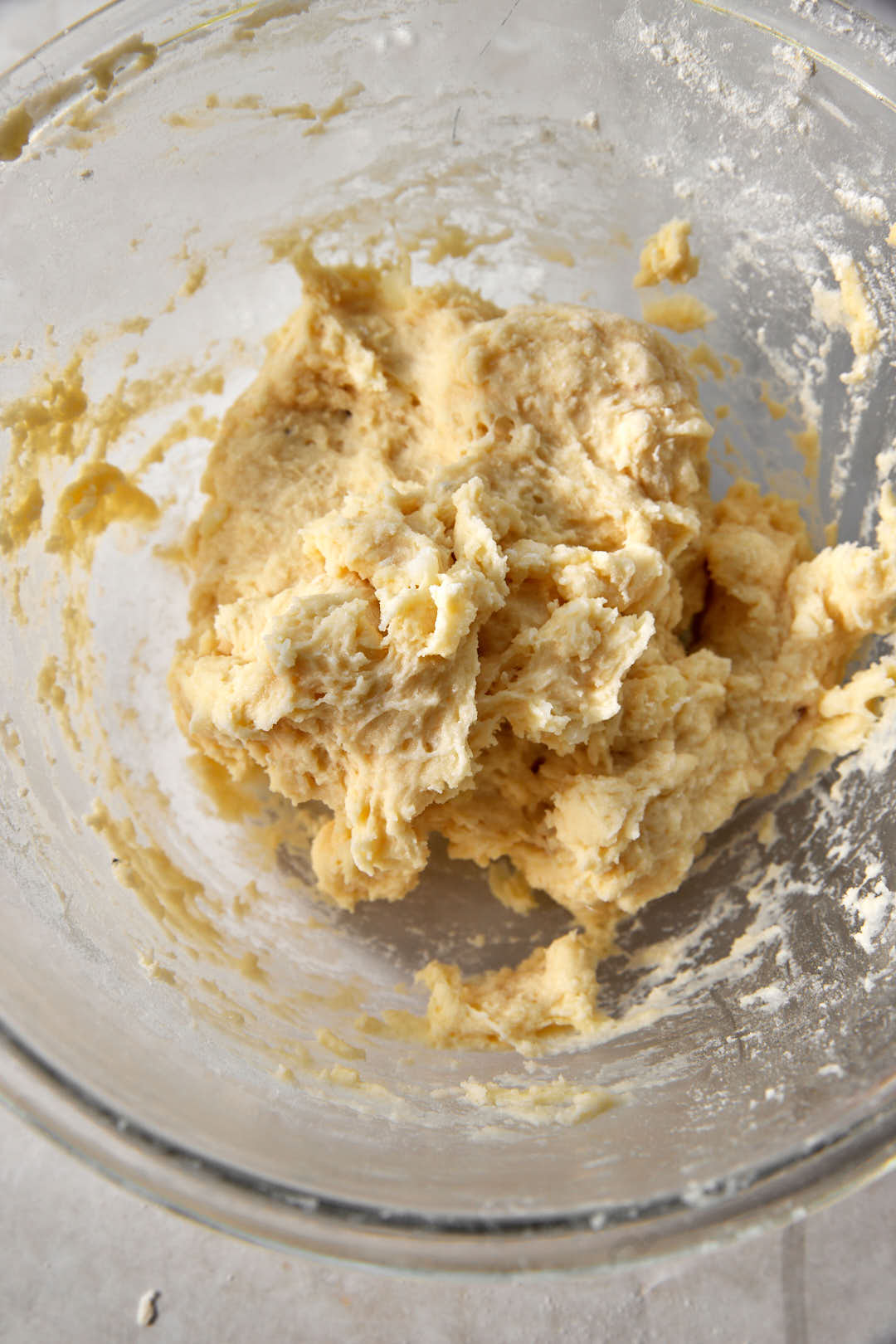 sticky gnocchi dough in a glass bowl.