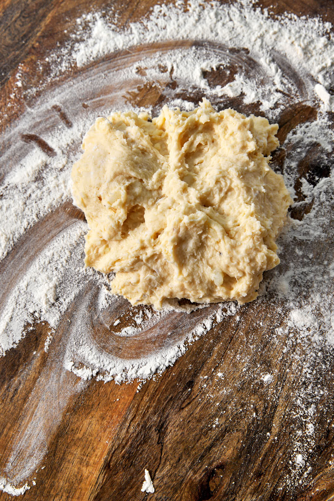 a gnocchi dough ball on a floured surface.