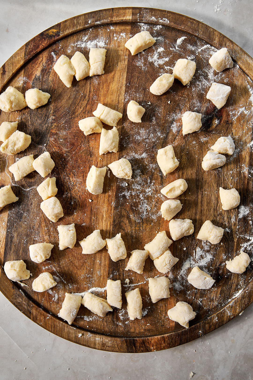 gnocchi cut into small pieces on a wooden surface.