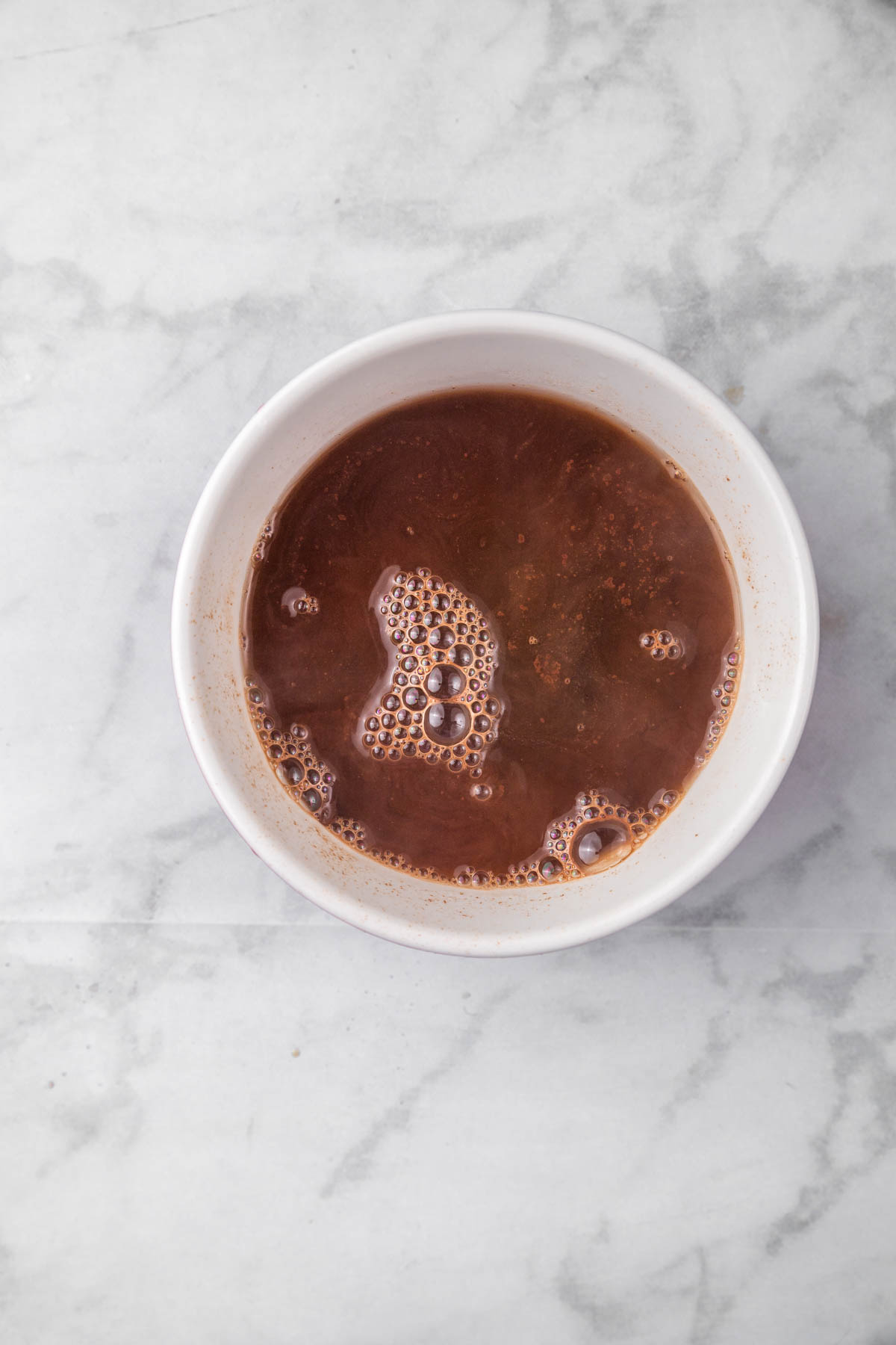 Chocolate sauce ingredients in a small white bowl.