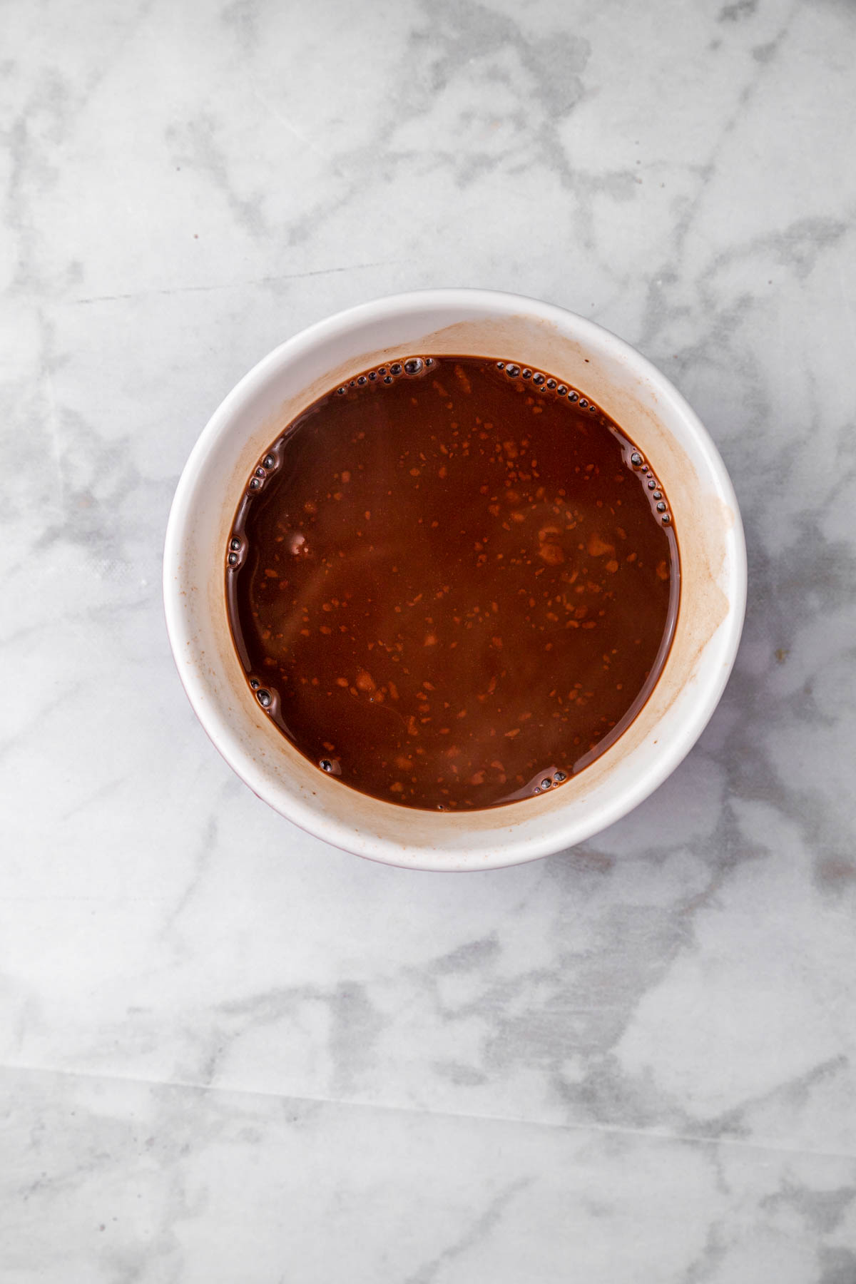 Mixed chocolate sauce ingredients in a white bowl.