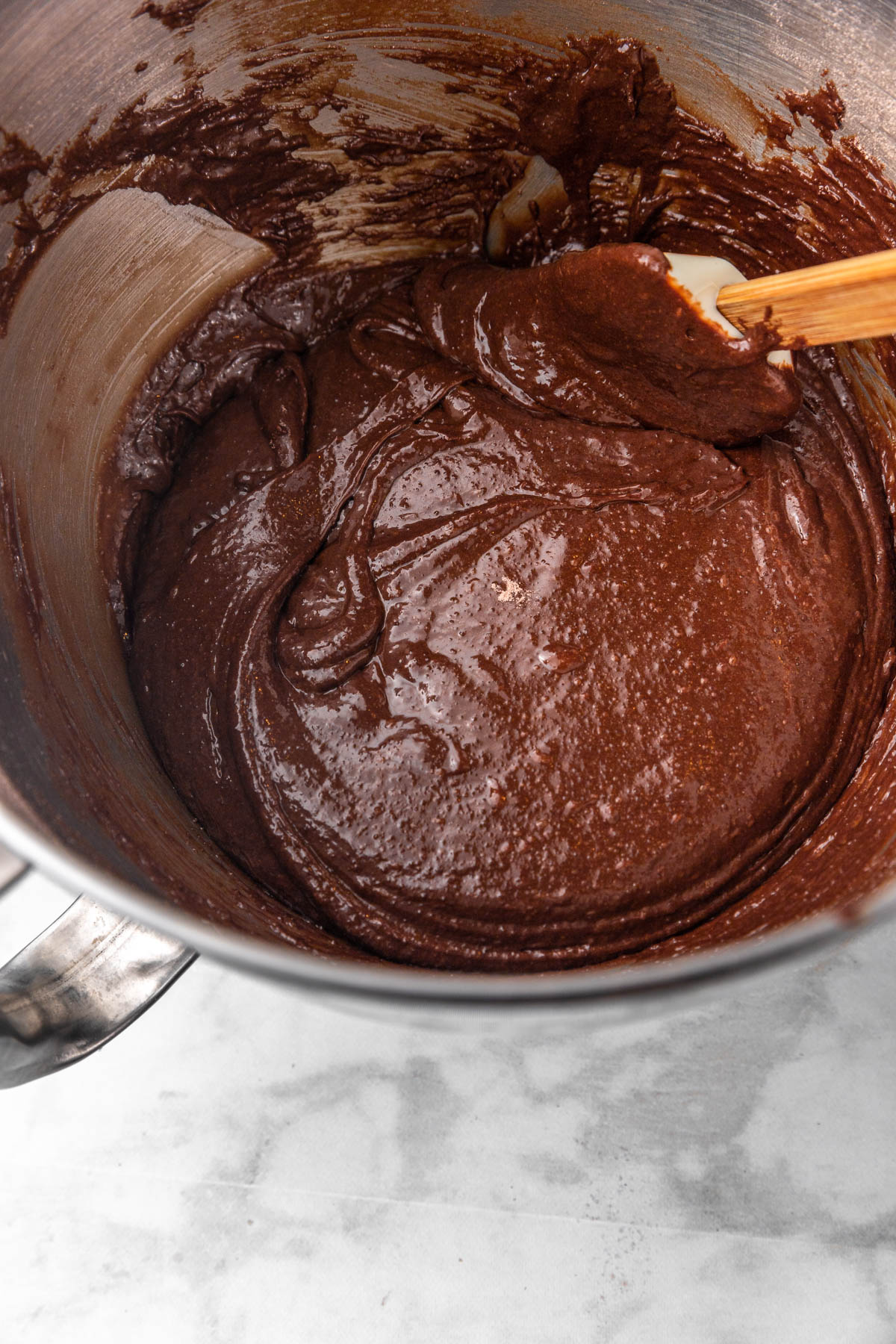 spatula scraping bowl to combine the cookie batter.