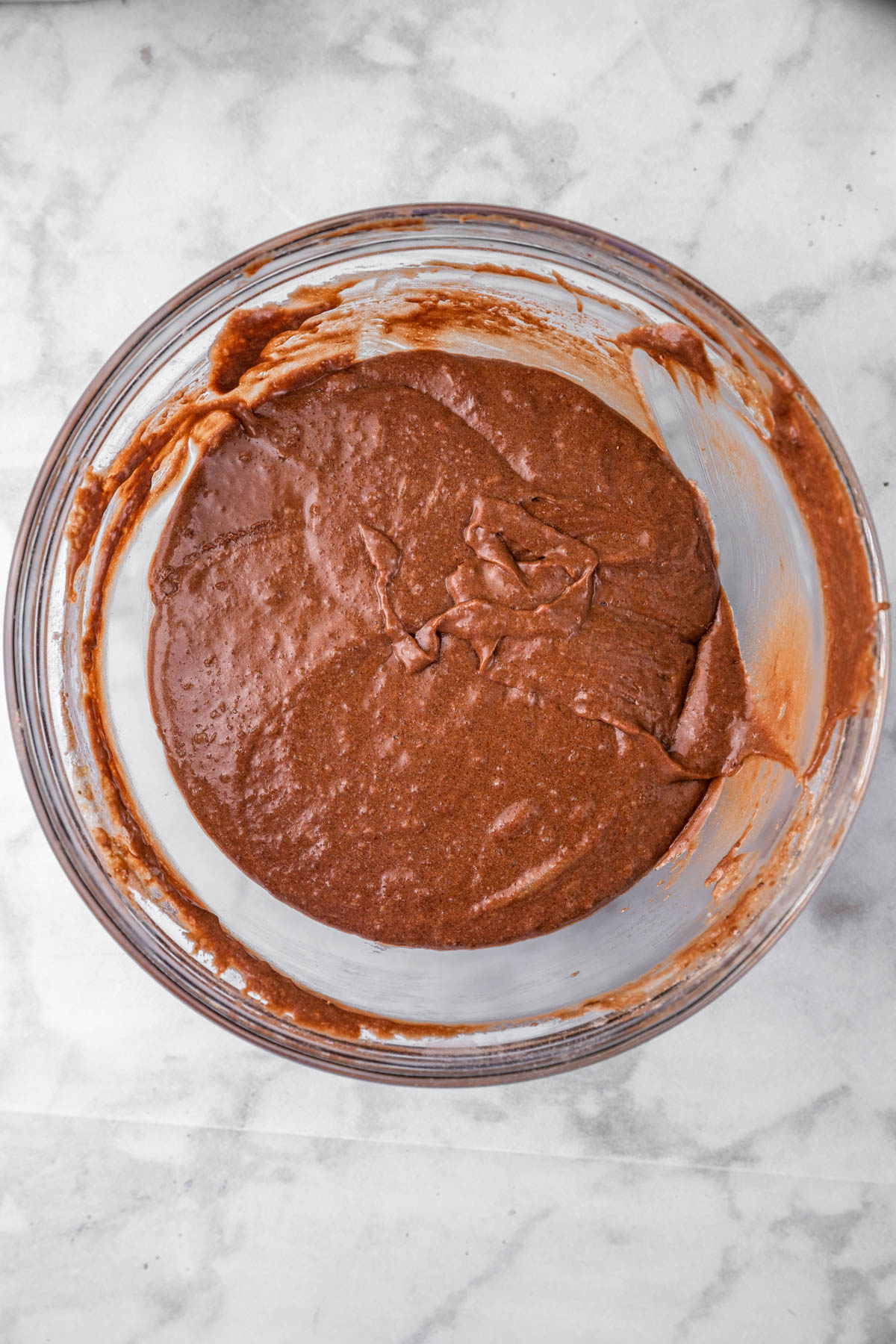 Mixed chocolate halva cake batter in a glass bowl.