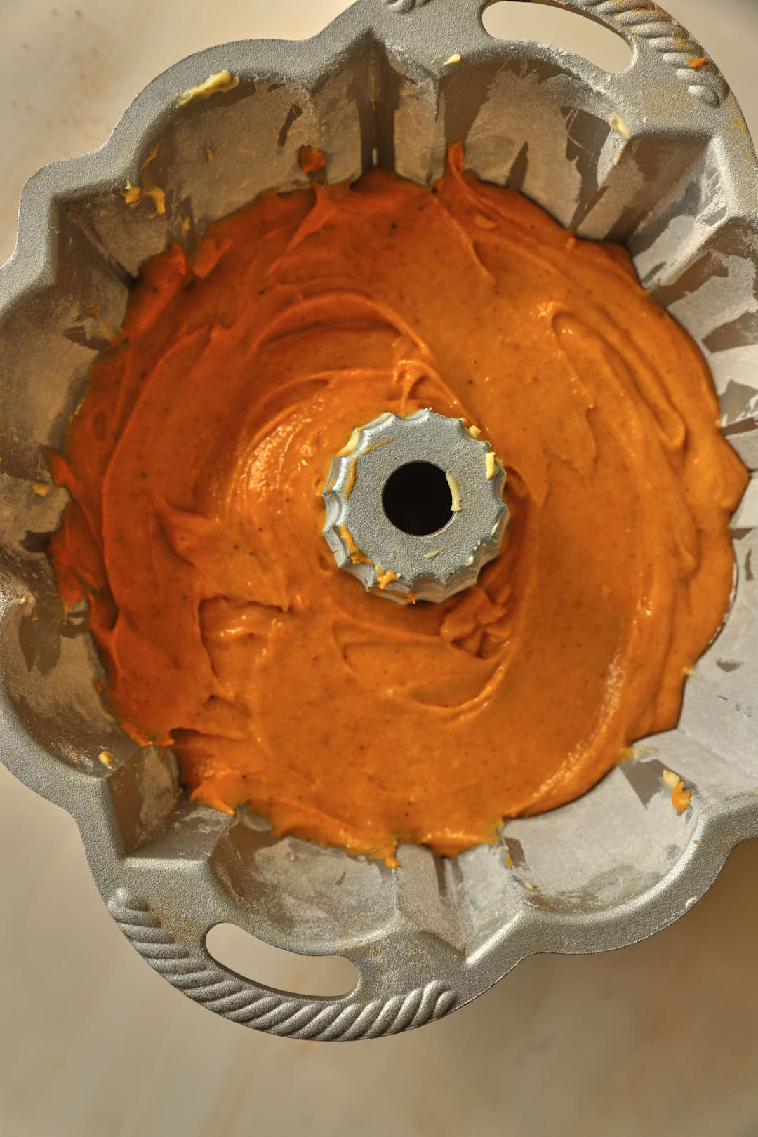 pumpkin cake batter in bundt cake pan before baking.
