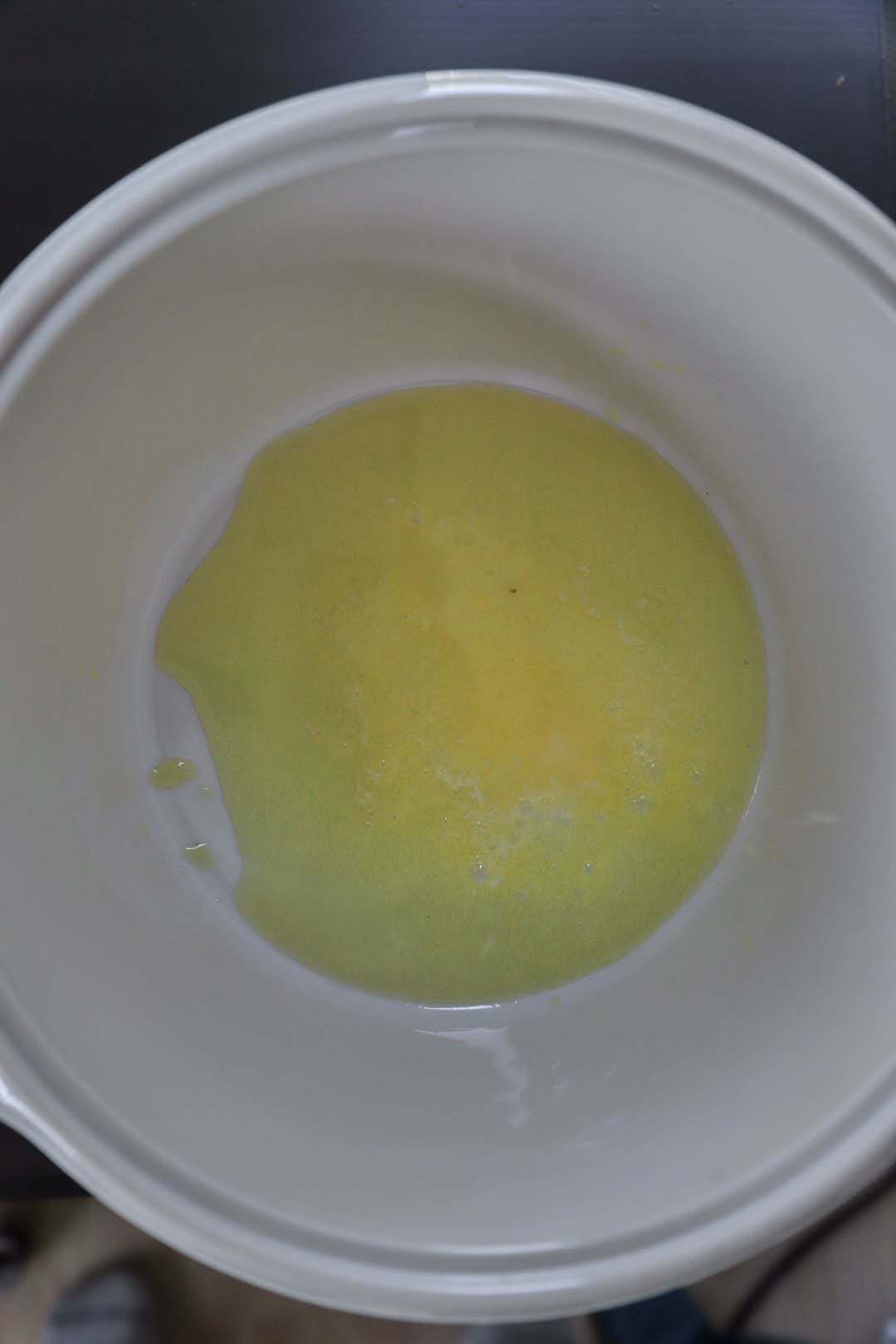 olive oil and butter melting in a white saucepan.
