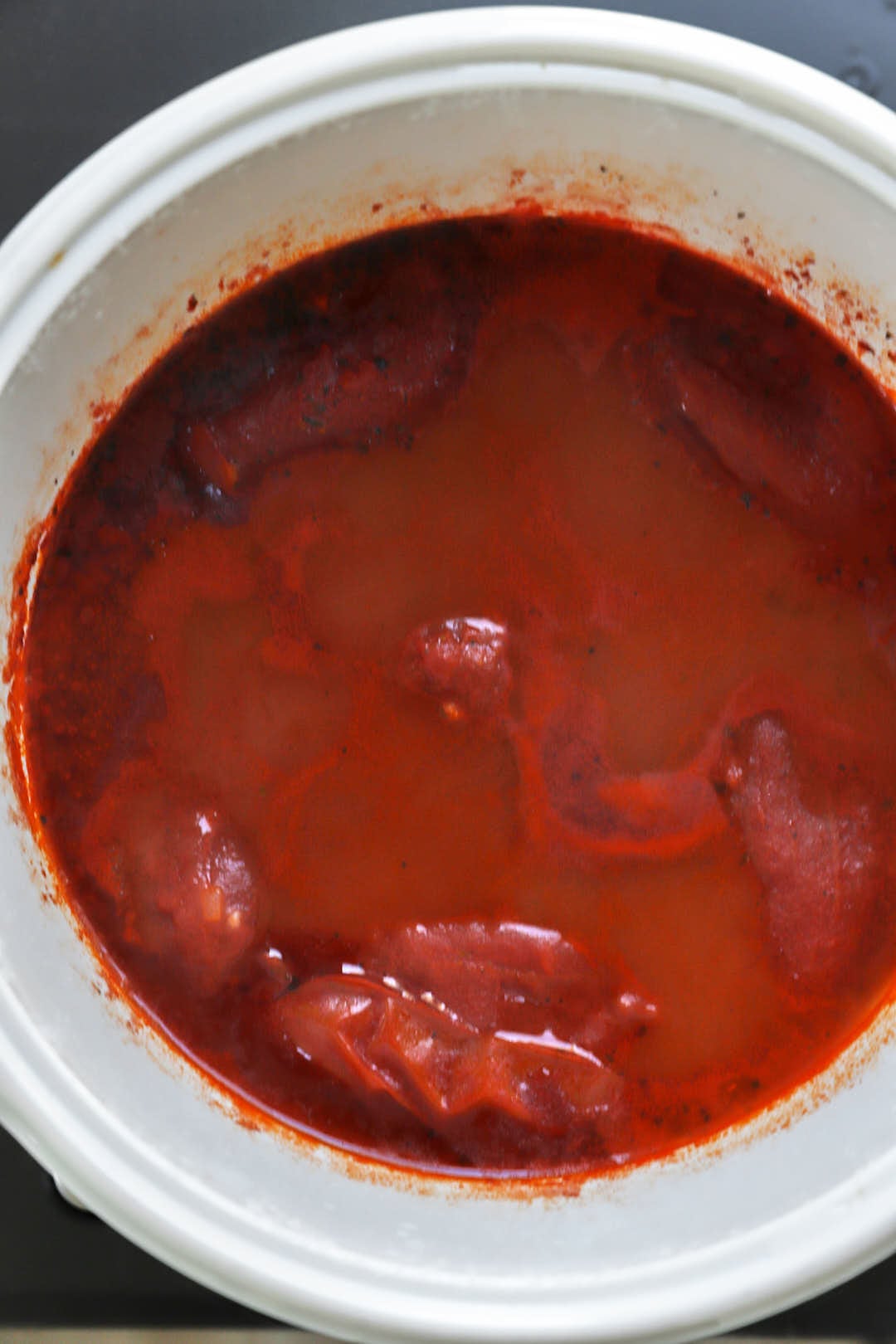 tomato soup after simmering in a white saucepan.