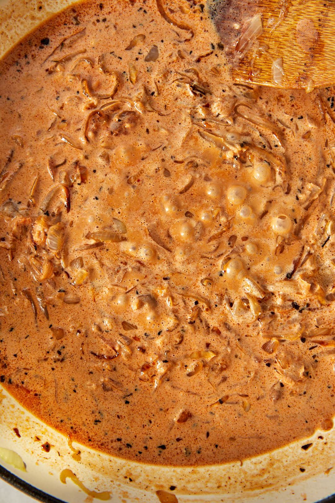 caramelized onion cream sauce gently bubbling in a skillet.