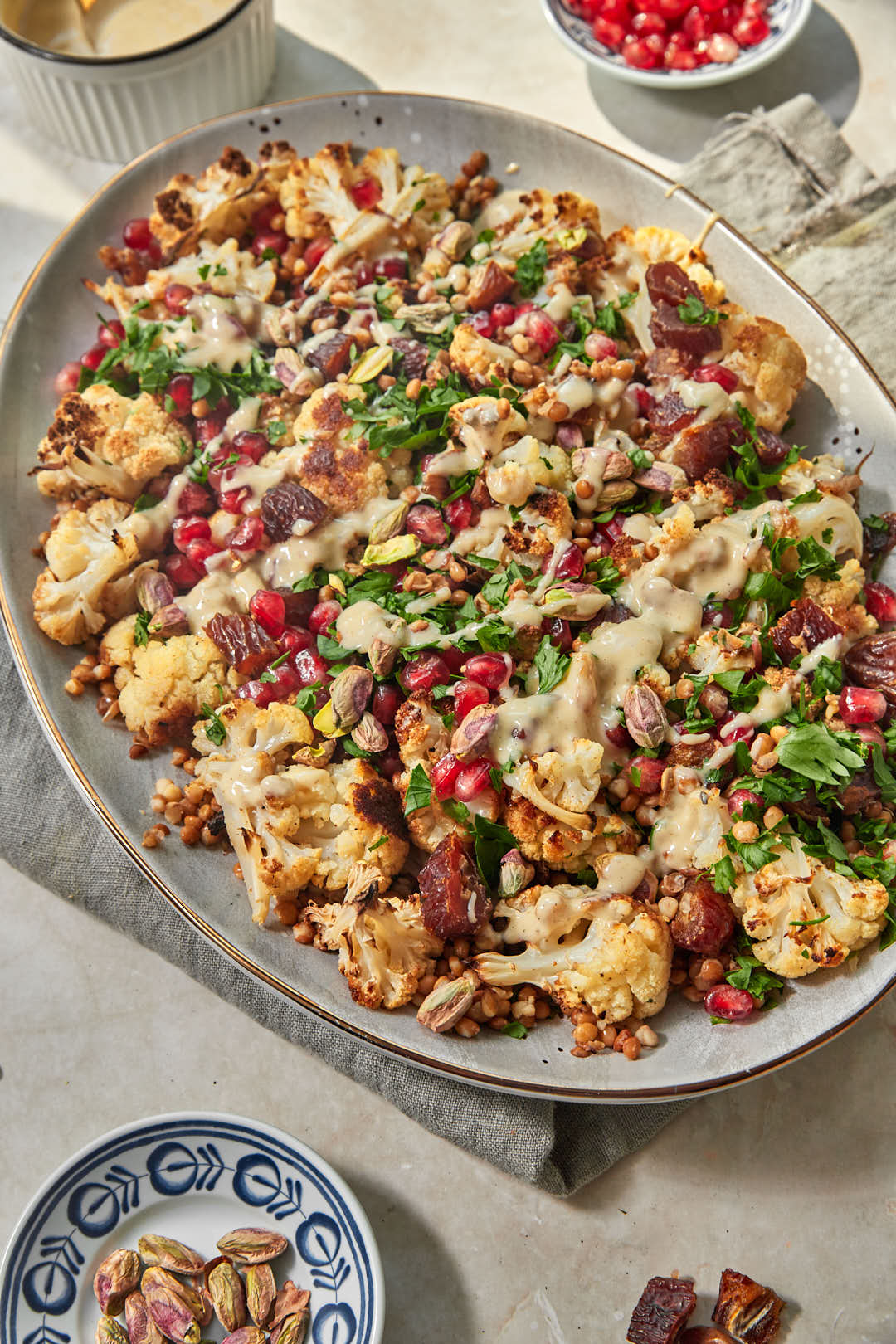 tahini dressing drizzled on lentil salad in a large serving platter.