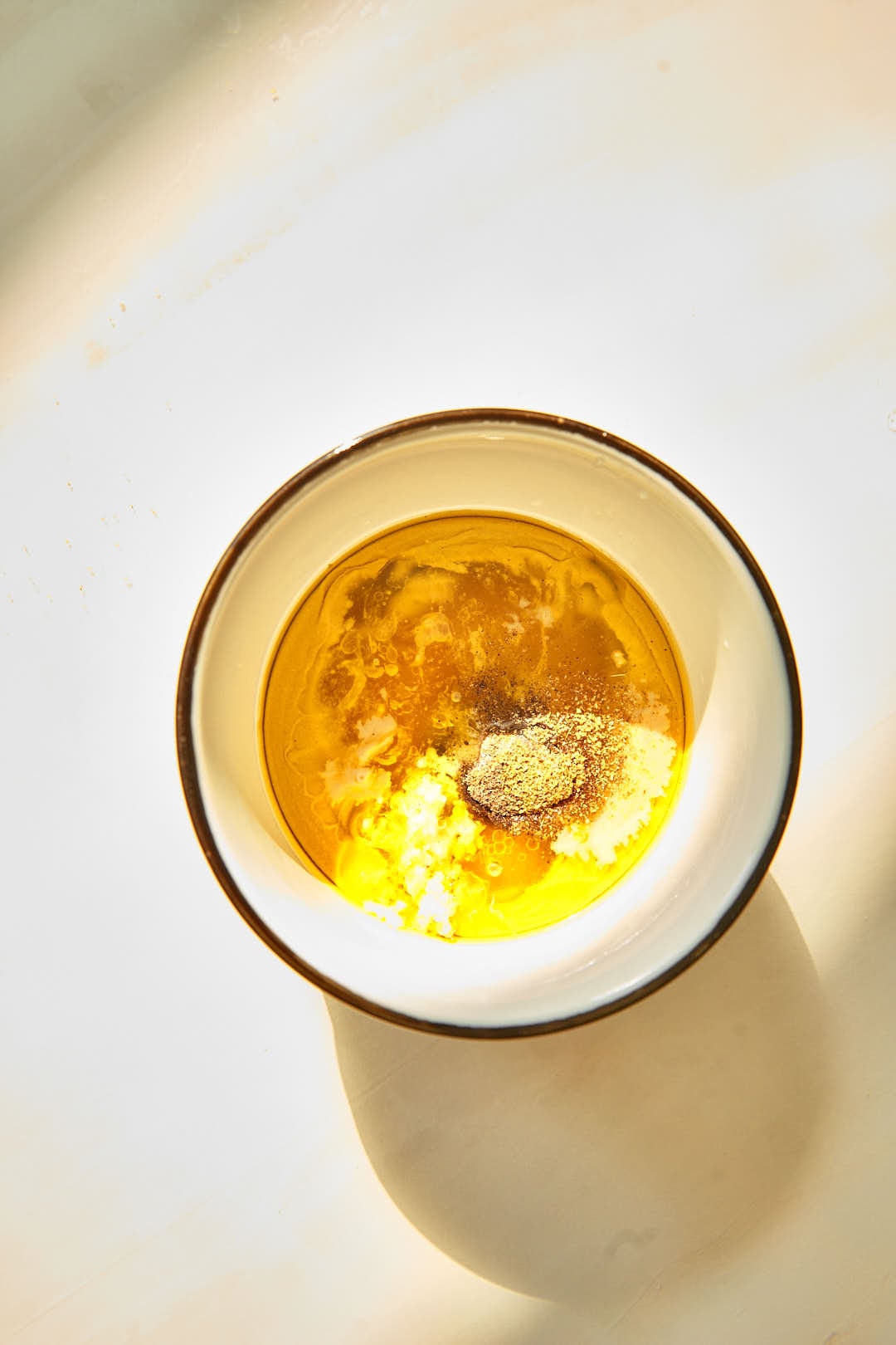 Whisk together the tahini, olive oil, lemon juice, honey, garlic, salt, black pepper, and cumin powder with a fork until creamy and well combined.